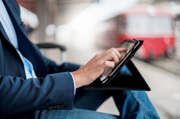 man on tablet, sitting