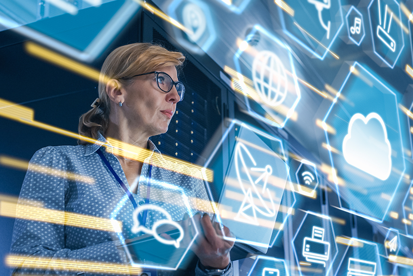 woman in front of transparent screen monitoring threats.