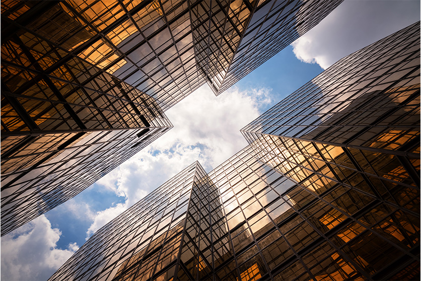 City buildings with blue sky above.