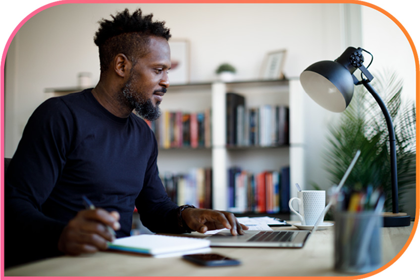 Man works at his desk on a laptop